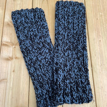 Load image into Gallery viewer, pair of blue and black leg warmers on a wooden table