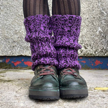 Load image into Gallery viewer, Purple knitted leg warmers worn with black shoes and tights against a textured wall.
